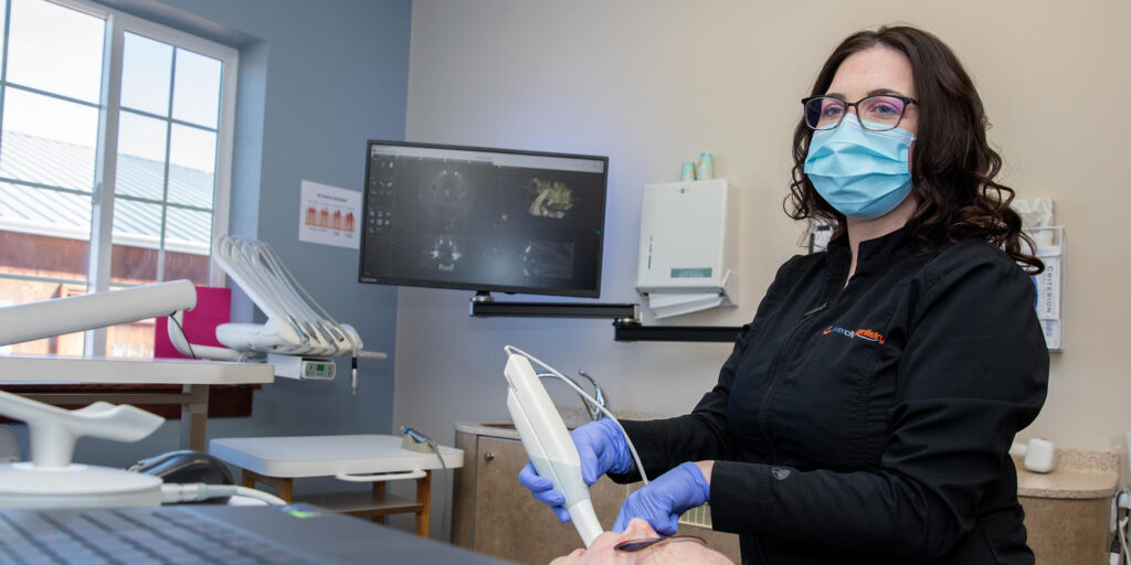 dental assistant scanning patients mouth